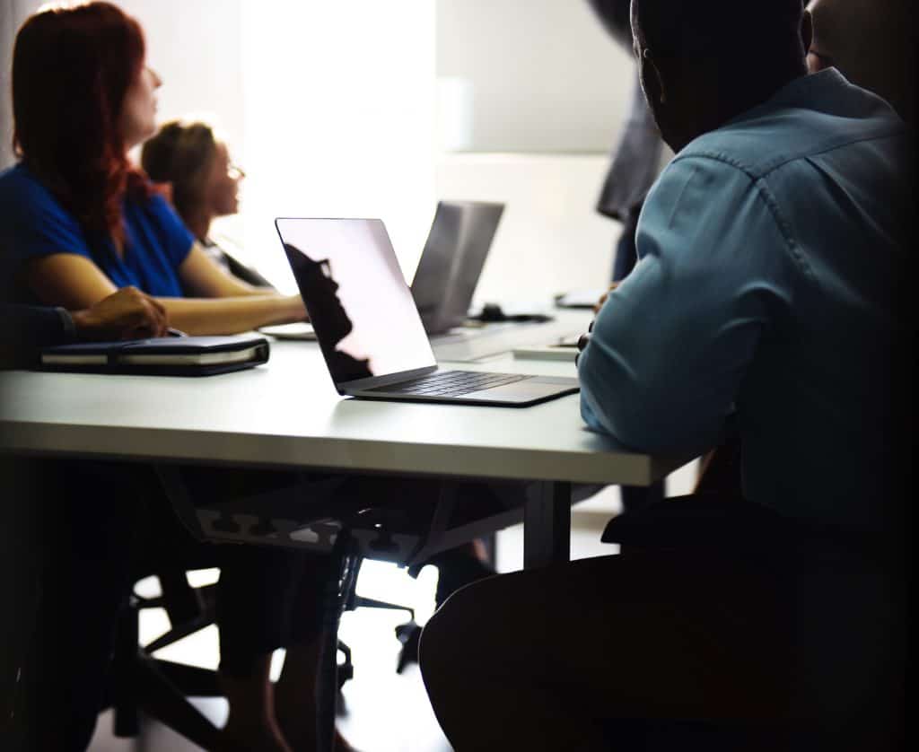 Business professionals at a conference table, learning about accounting technology