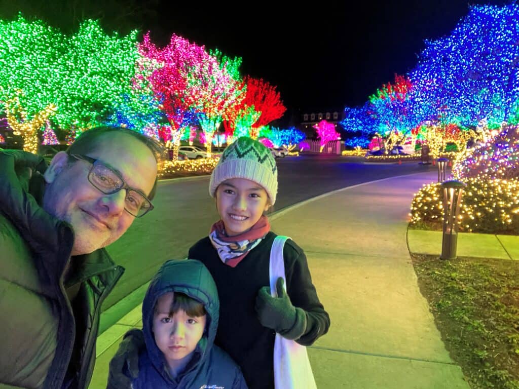 Gyan Kanal with family, outdoors colorful holiday lights