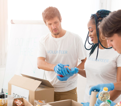 Volunteers packing up donation boxes.