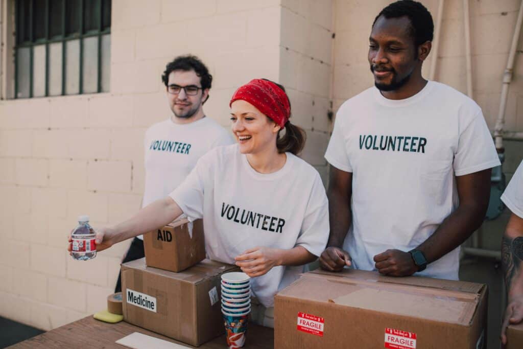 Volunteers handing goods