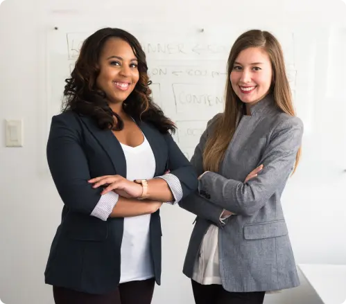 Business women standing next to each other.